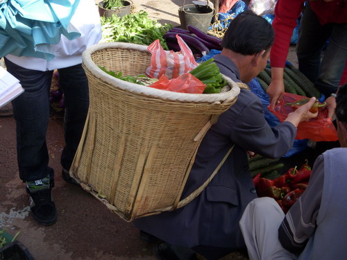 背着满是物品的背篓的阿伯