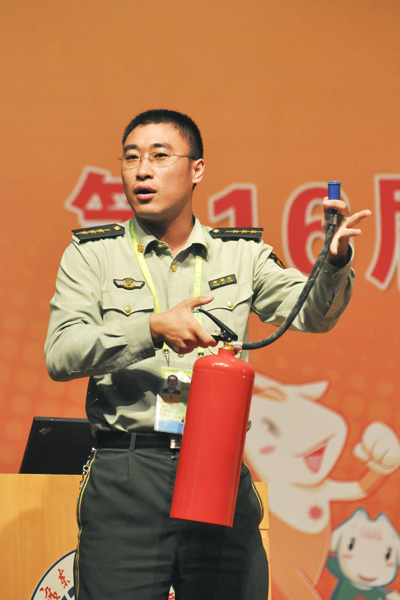 消防防火主管郑家亮演示灭火器的使用方法