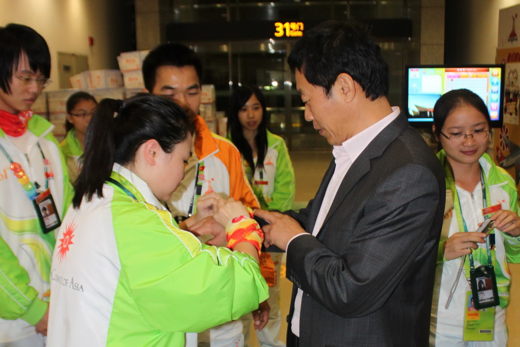 我校志愿者为许国彬佩戴志愿彩